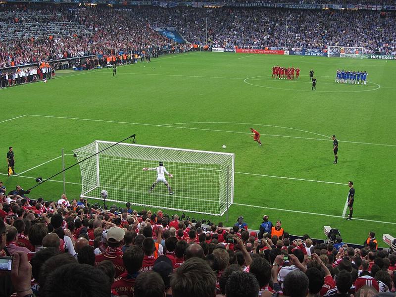 Players standing in the center circle during a penalty shoot-out
